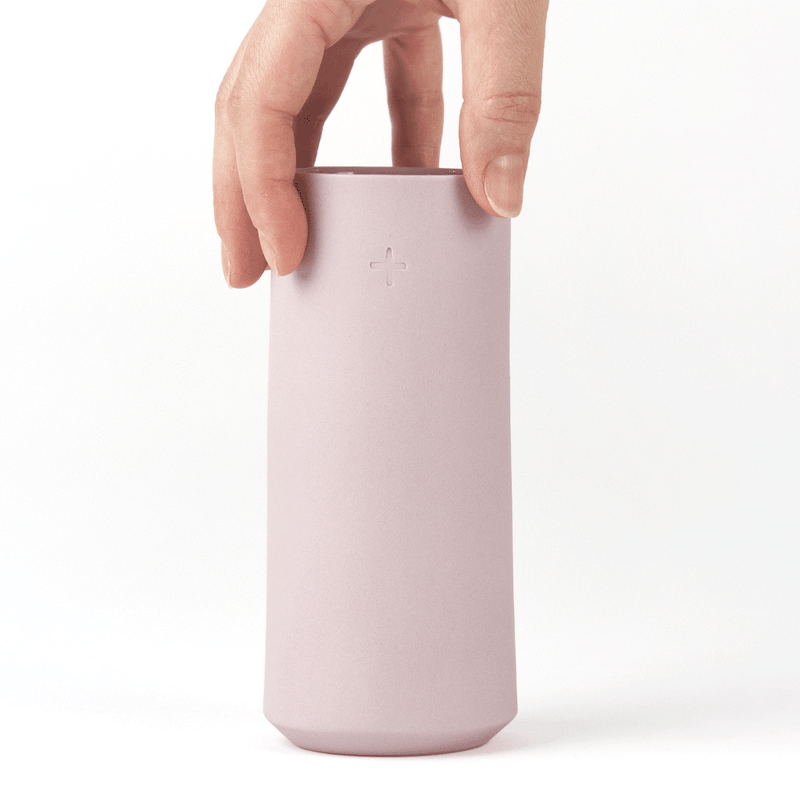 hand holding a lavender porcelain highball glass