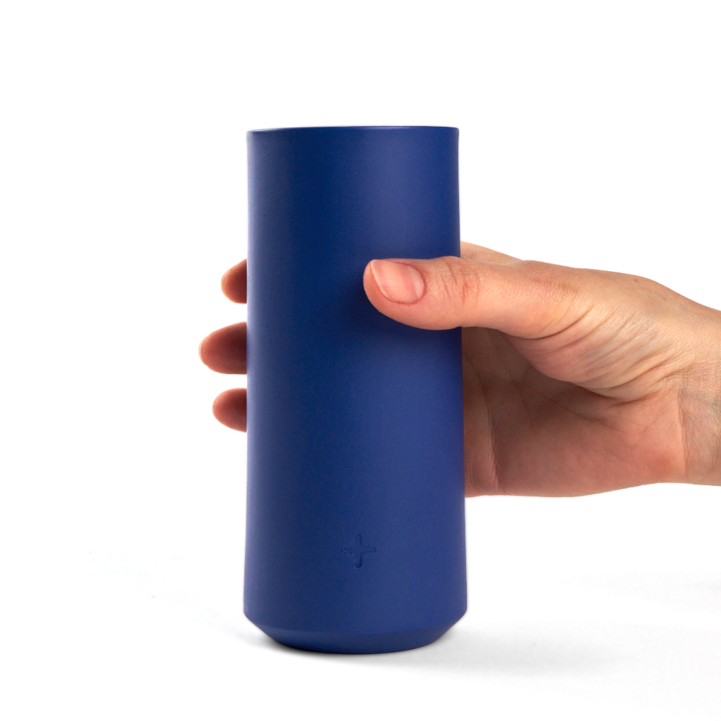 hand holding a porcelain highball glass in dark blue