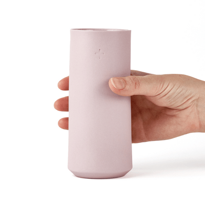 hand holding a lavender porcelain highball glass