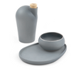 A light grey colored carafe next to a light grey pairing plate and matching light grey copita.
