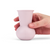 A hand holding a Lavender colored TUYO tequila sipping glass