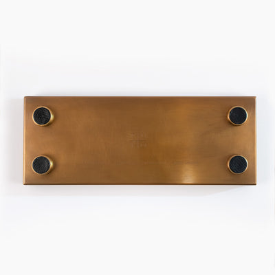 bottom of brass mezcal flight tray with engraved TUYO logo