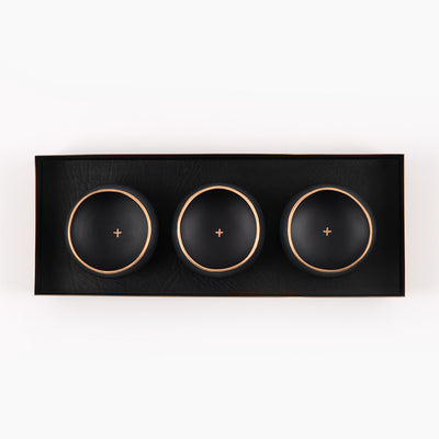 brass and black leather tray with black and gold porcelain copitas
