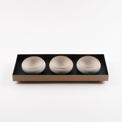 brass and black leather tray with three white and gold copitas for a flight of mezcal