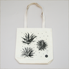 Detail of natural canvas tote bags with six different agave plants printed with black ink on the front and back
