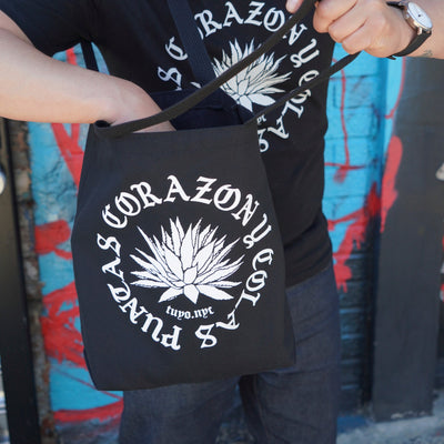 Black tote bag silkscreened with the words Puntas, Corazon y Colas and an agave plant in the center