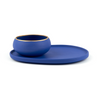 Side view of our mezcal copita and plate set in dark blue porcelain